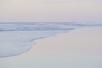 A peaceful morning scene of Kaapil beach with gentle waves and soft sand.