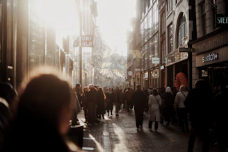 A busy urban commercial property with signage and bustling foot traffic during golden hour.