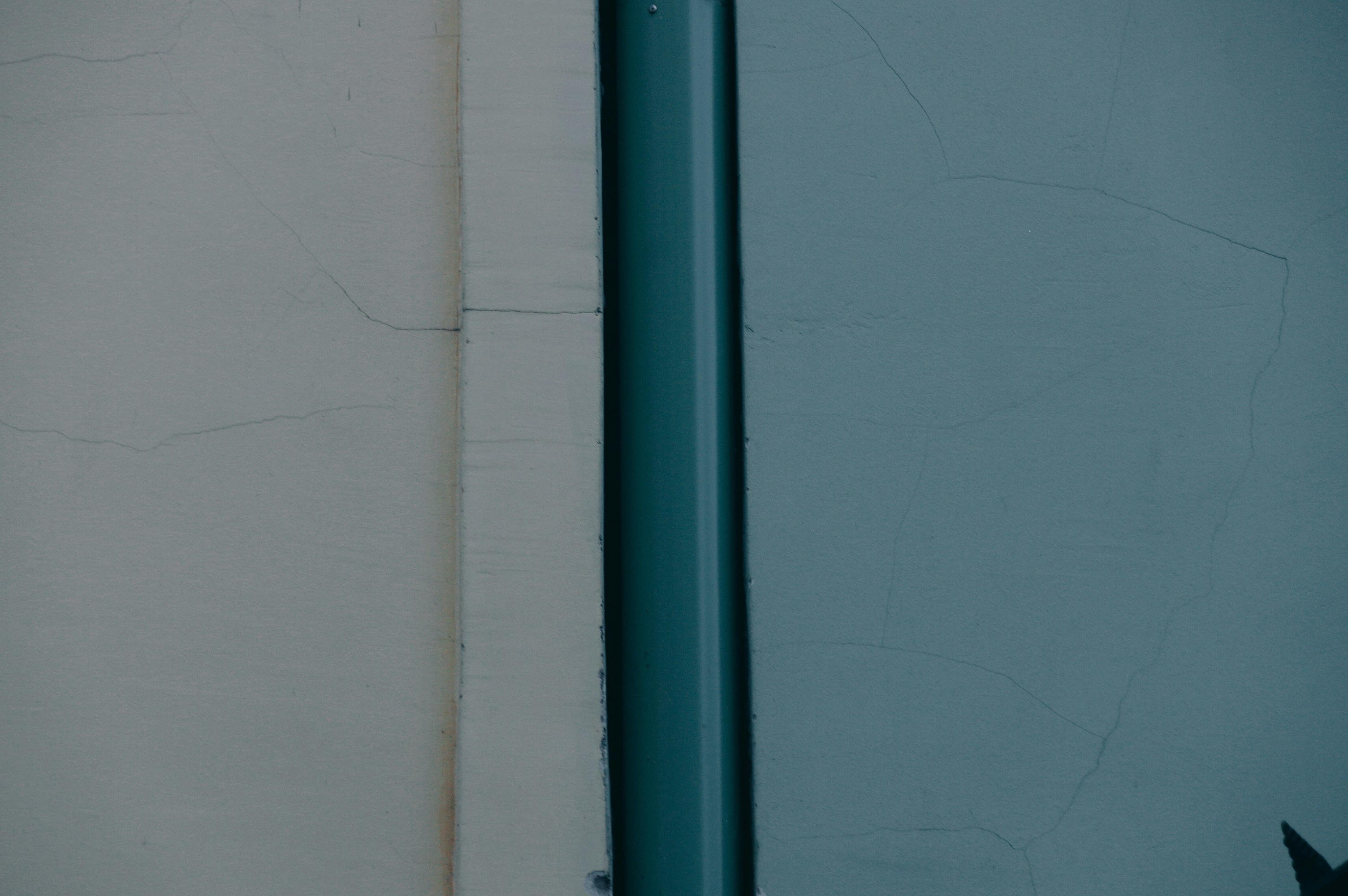 a black cat sitting on top of a window sill