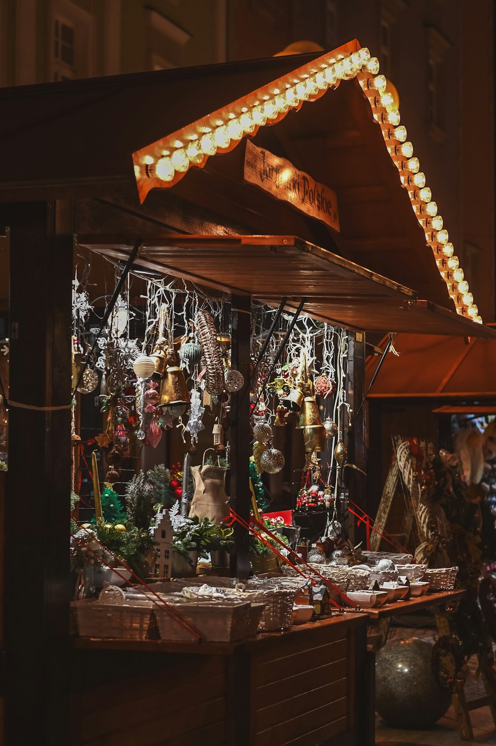a christmas market with lights and ornaments on display