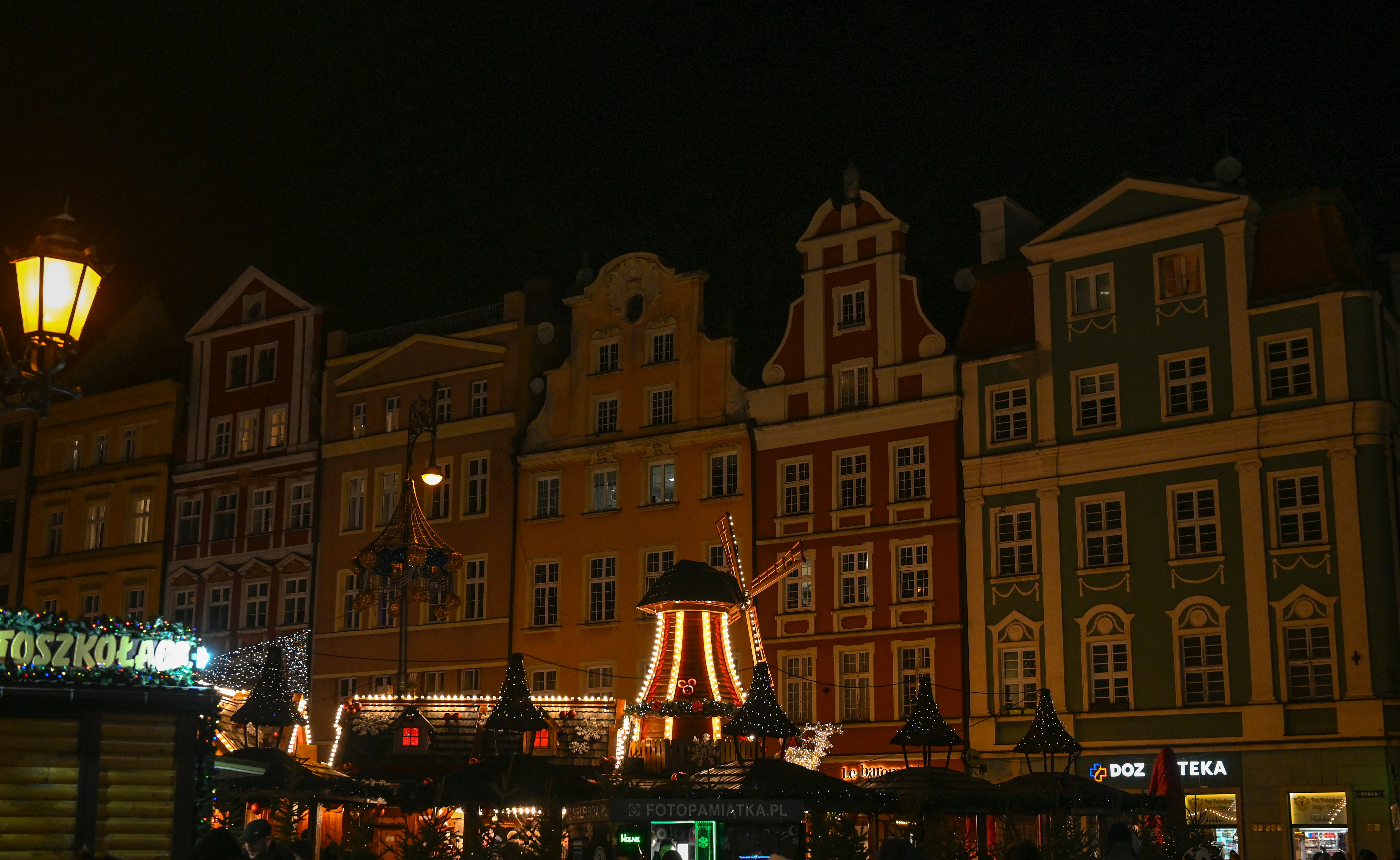 a large building with a lit up christmas tree in front of it