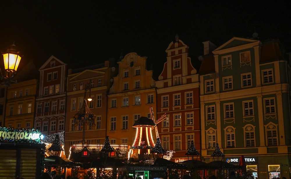 a large building with a lit up christmas tree in front of it