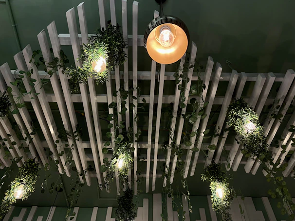Solar ceiling lights casting a warm, eco-friendly glow over a minimalist dining area with green decor.