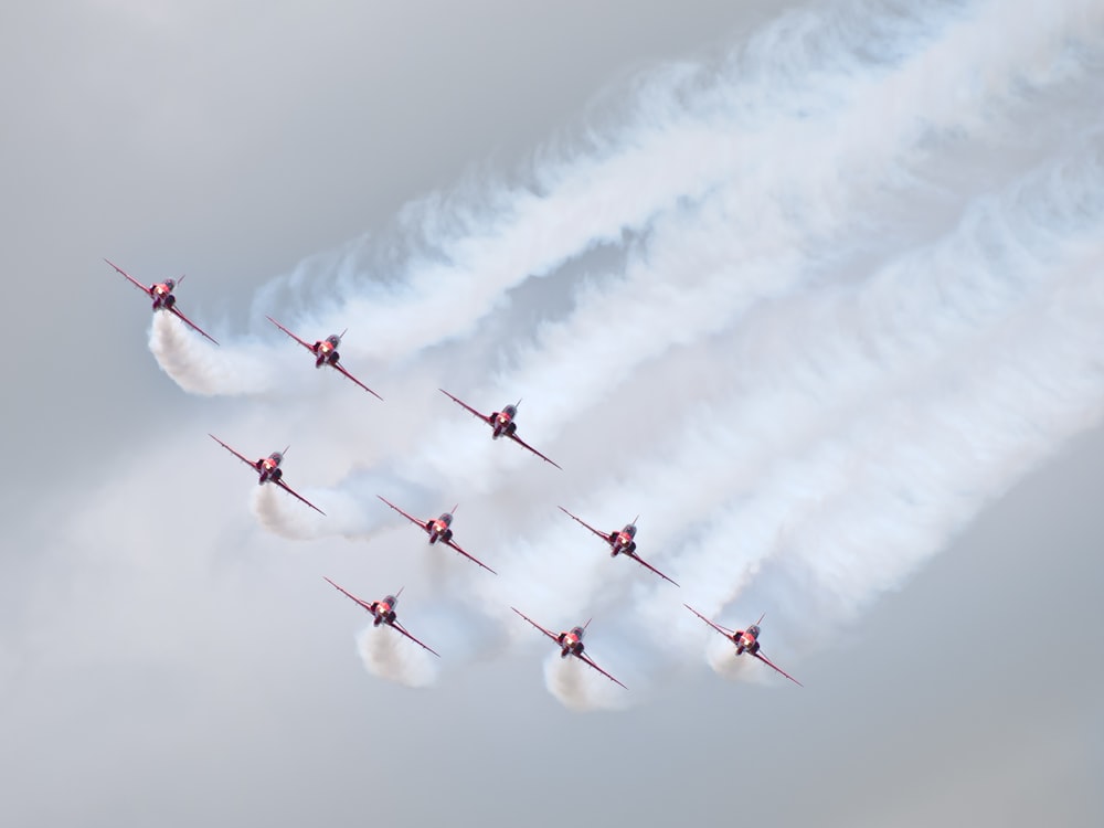 a group of planes flying in formation in the sky