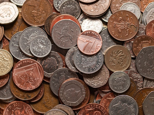 a pile of different types of coins