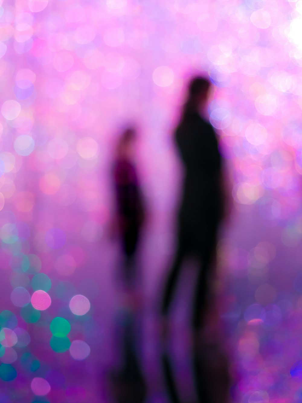 a blurry photo of two people standing next to each other