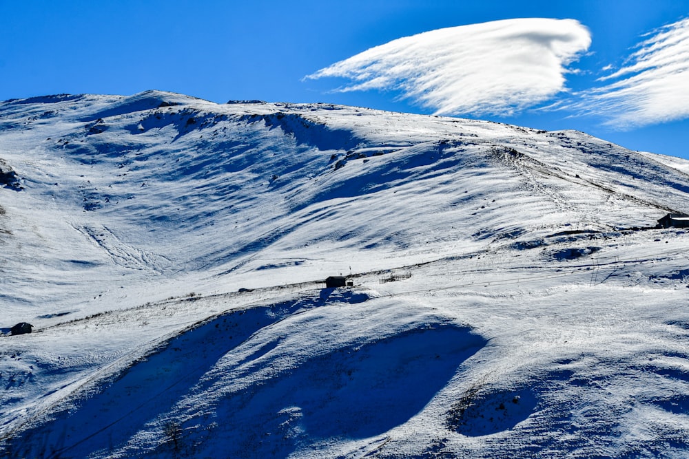 a mountain covered in snow under a blue sky