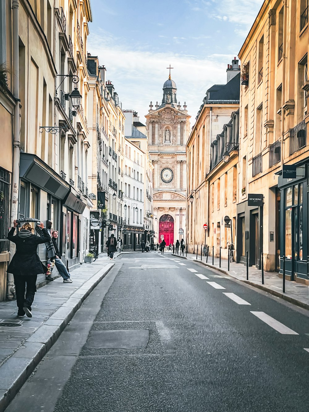 a city street with a clock tower in the background