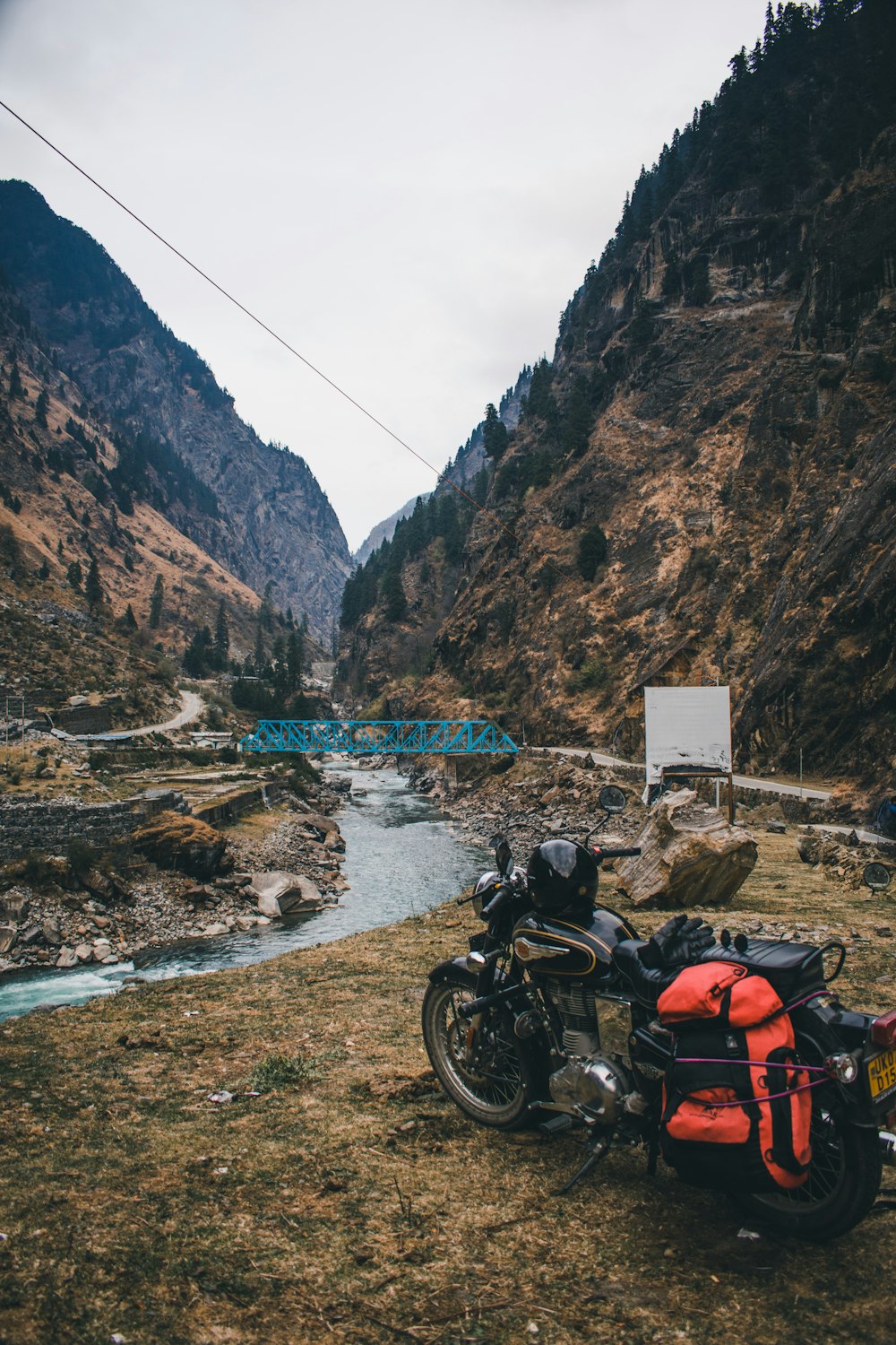 a motorcycle parked on the side of a mountain