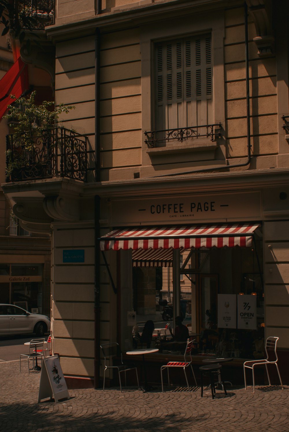 a coffee shop with a red and white awning