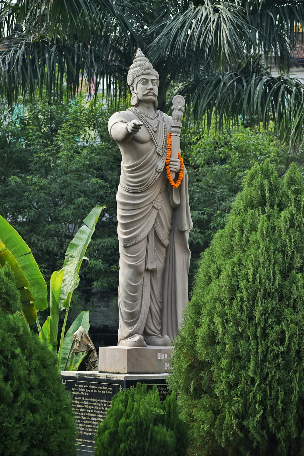 a statue of a person with a wreath around his neck