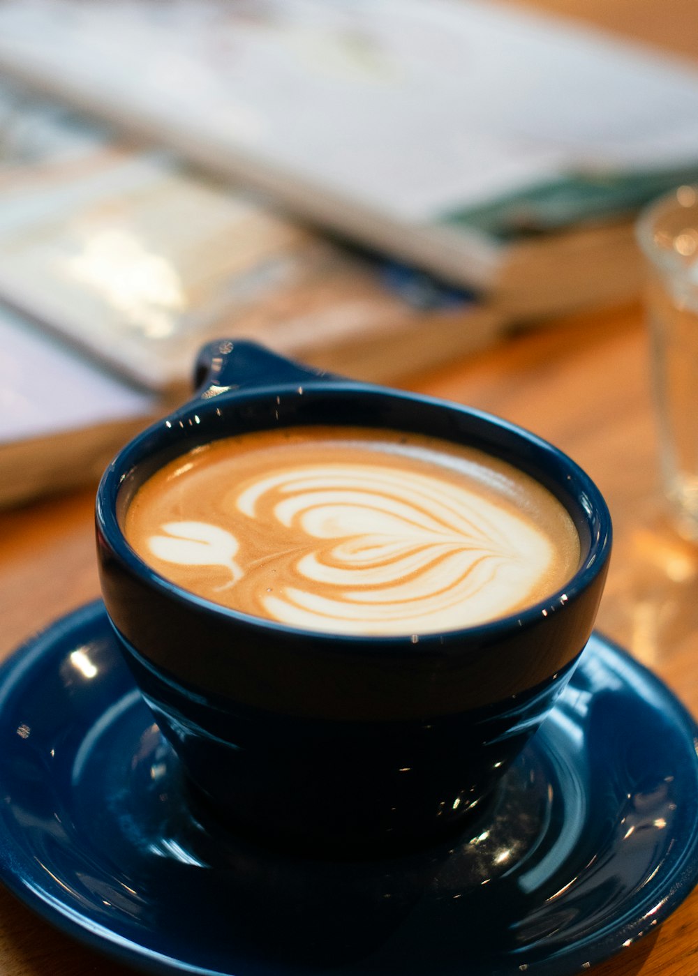 a cup of coffee on a saucer on a table