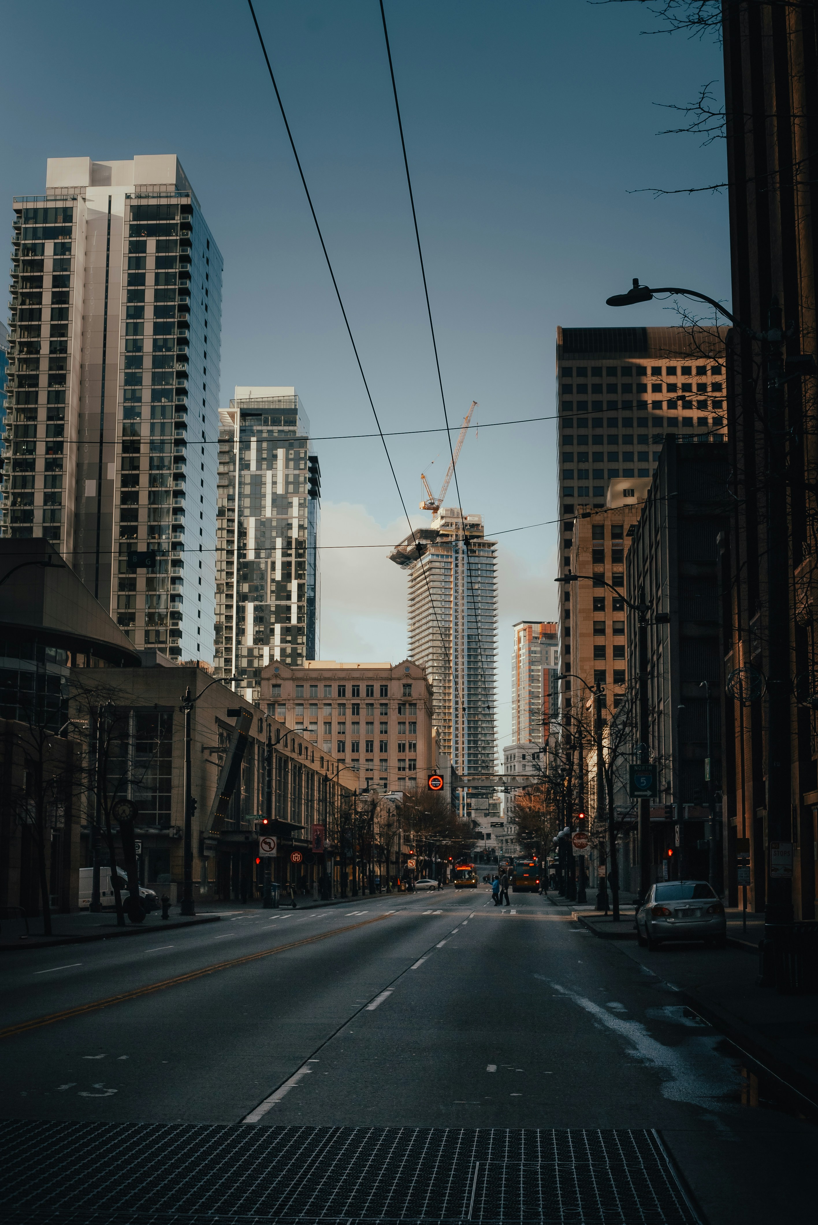 a city street with tall buildings in the background