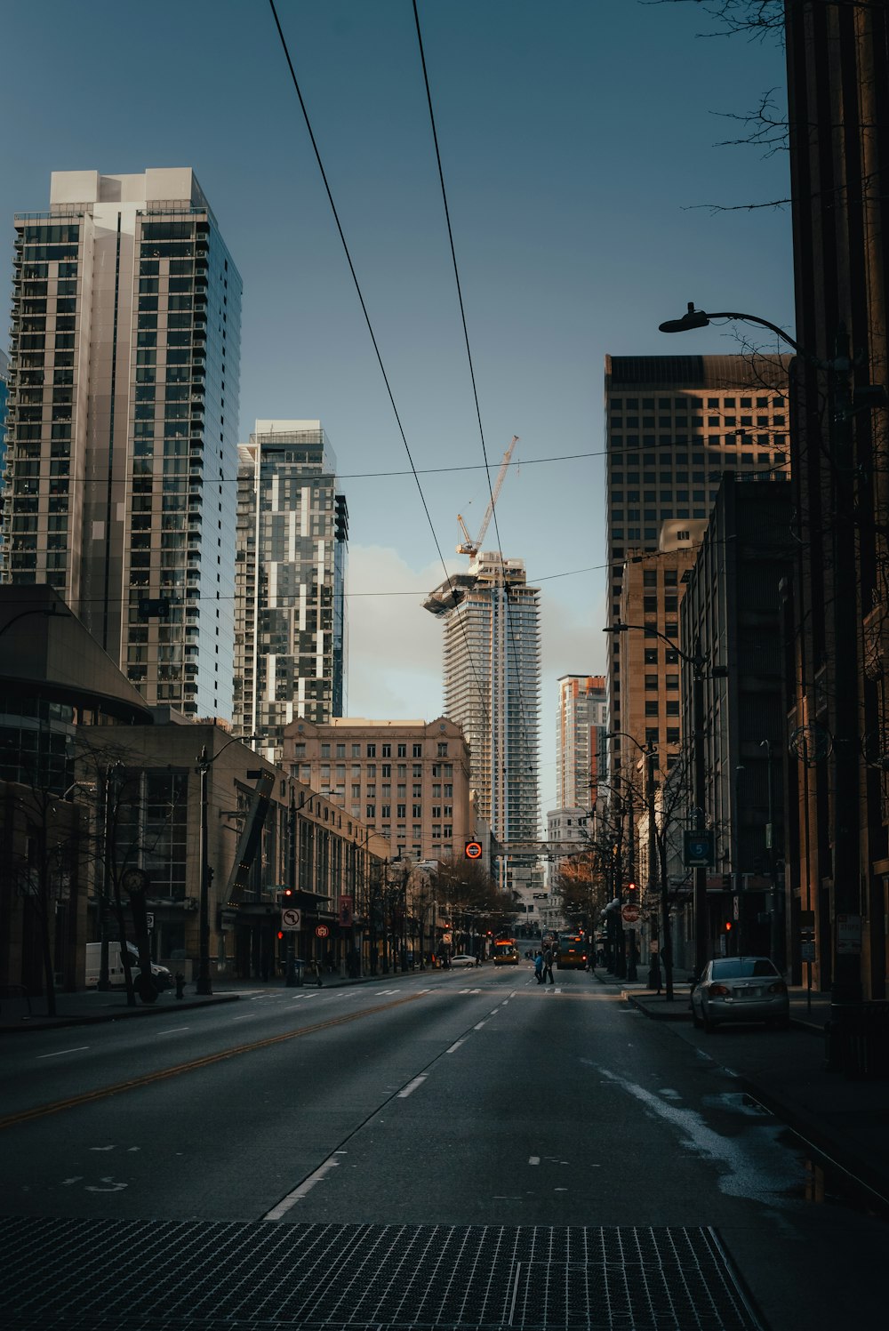 a city street with tall buildings in the background