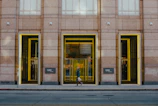 Wide sidewalk with smooth concrete surface leading to a commercial building entrance.