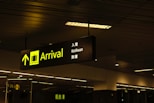 a black and yellow sign hanging from a ceiling