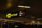 a black and yellow sign hanging from a ceiling