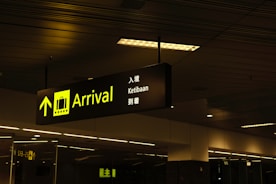 a black and yellow sign hanging from a ceiling