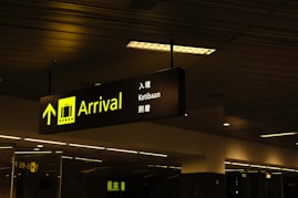 a black and yellow sign hanging from a ceiling