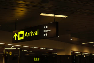 a black and yellow sign hanging from a ceiling