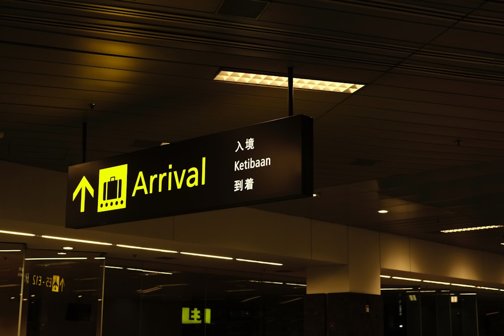 a black and yellow sign hanging from a ceiling