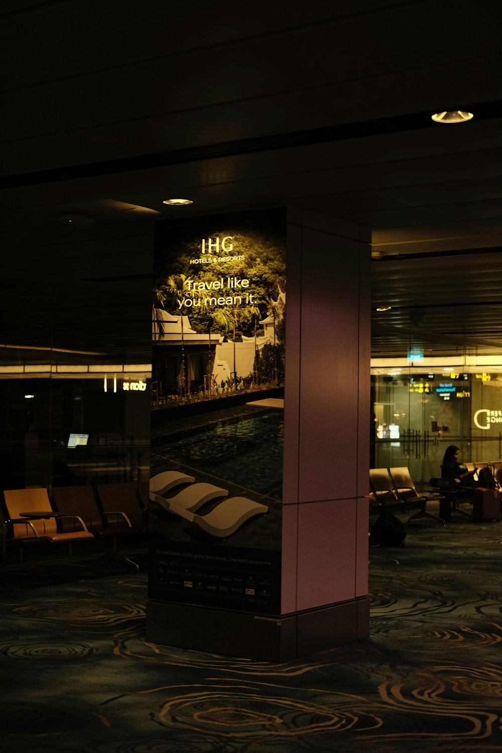 a lobby area with a large poster on the wall