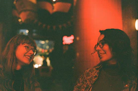 Smiling patient chatting with a friendly optician in a cozy office