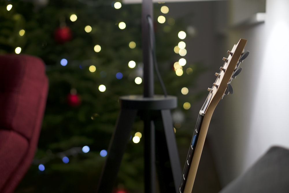 a guitar sitting in front of a christmas tree