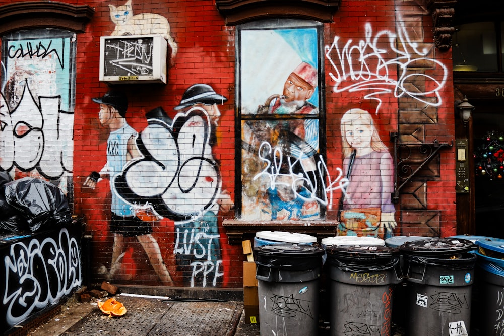 a red brick building with graffiti all over it