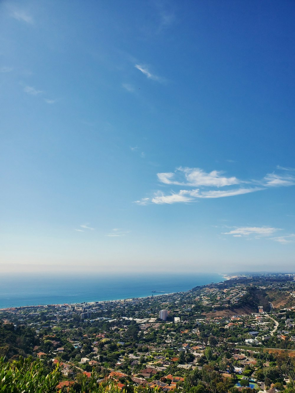 a scenic view of a city and the ocean