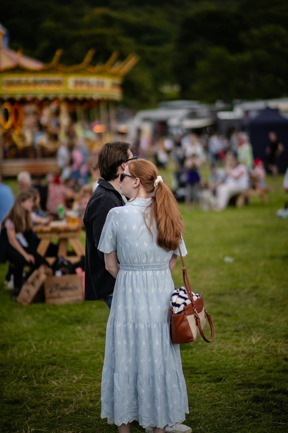 a woman in a white dress standing next to a man