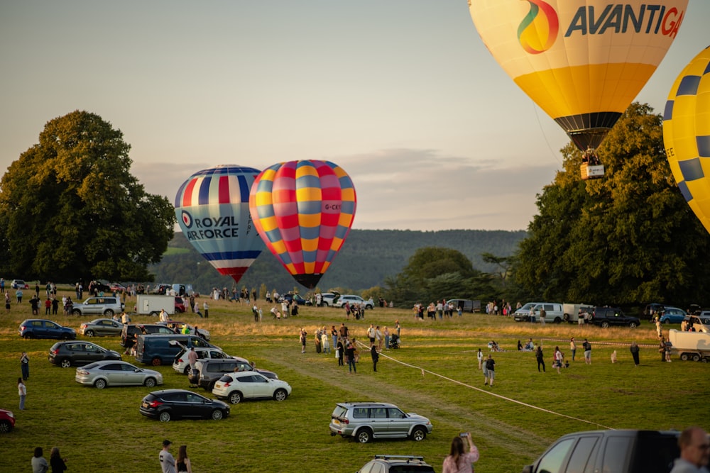 several hot air balloons in the sky over a field