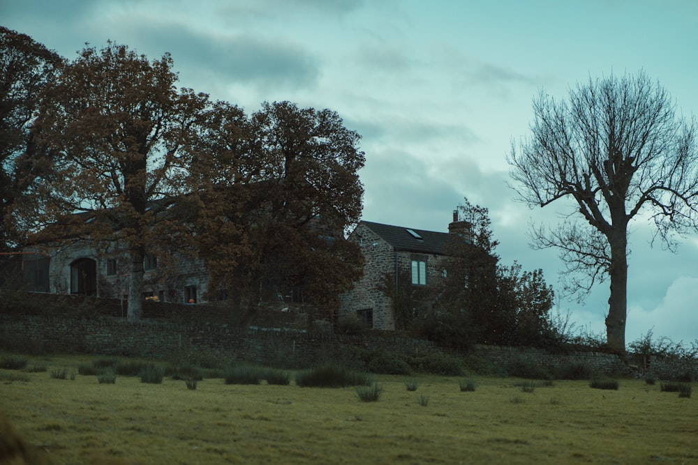 a large house sitting on top of a lush green field