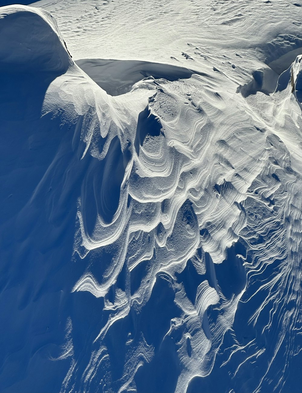 a view of a snow covered mountain from the air