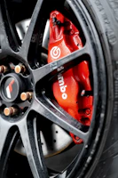 Close-up of a rugged Forgeline brake caliper installed on a heavy-duty truck wheel.