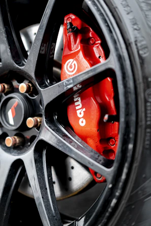 Close-up of a rugged Forgeline brake caliper installed on a heavy-duty truck wheel.
