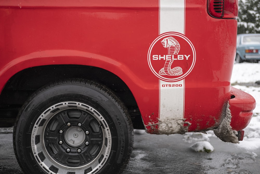 a red and white truck parked in a parking lot