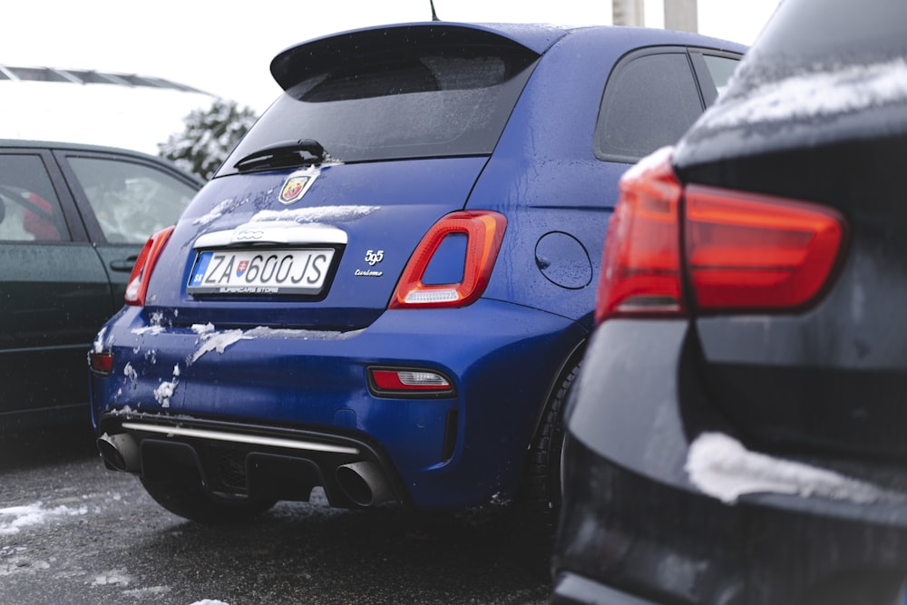 a couple of cars parked next to each other in a parking lot