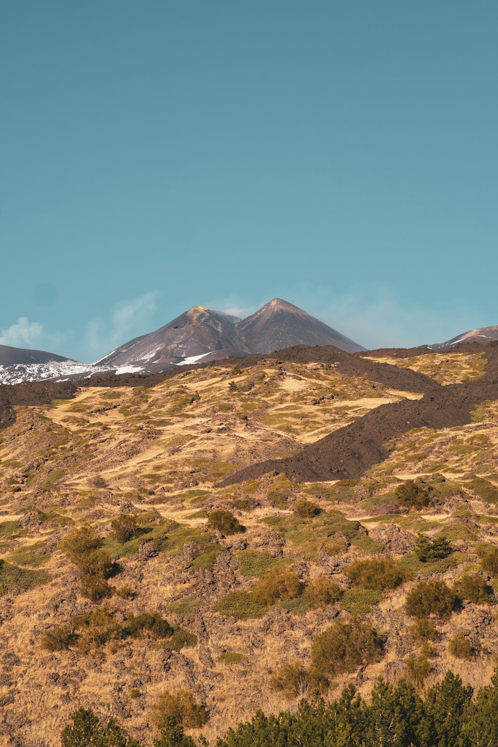 a mountain with a few snow on top of it