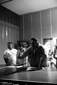 A lively group of table tennis players sharing a joyful moment after a match.