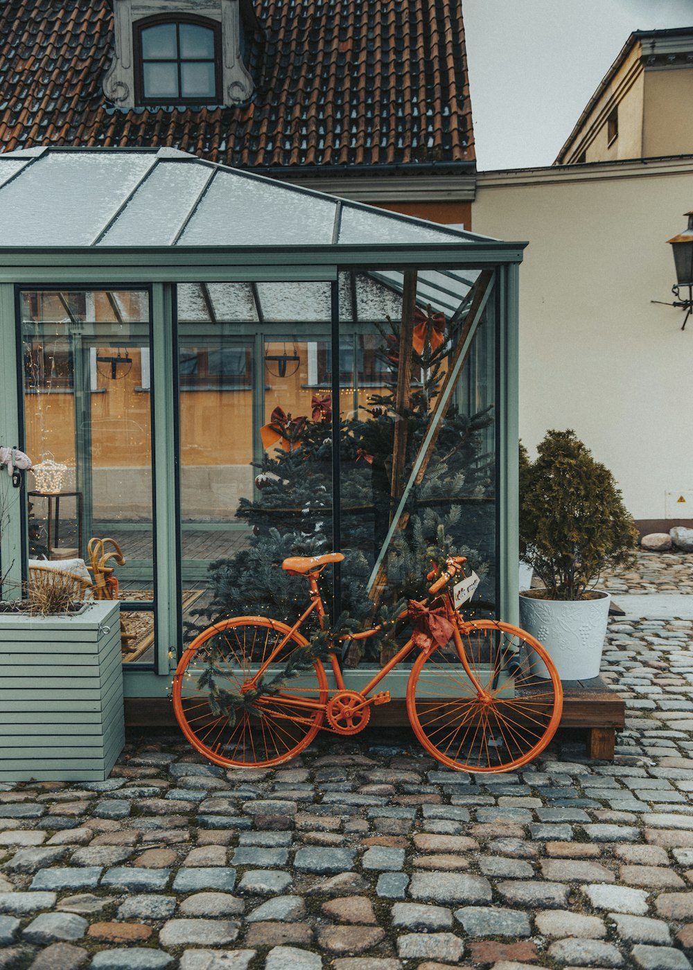 an orange bicycle parked in front of a building