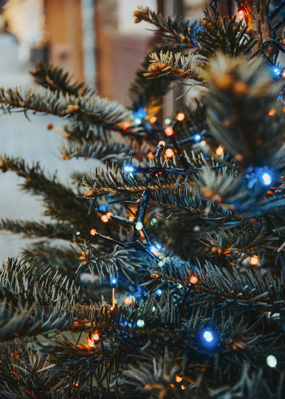 a close up of a christmas tree with blue lights