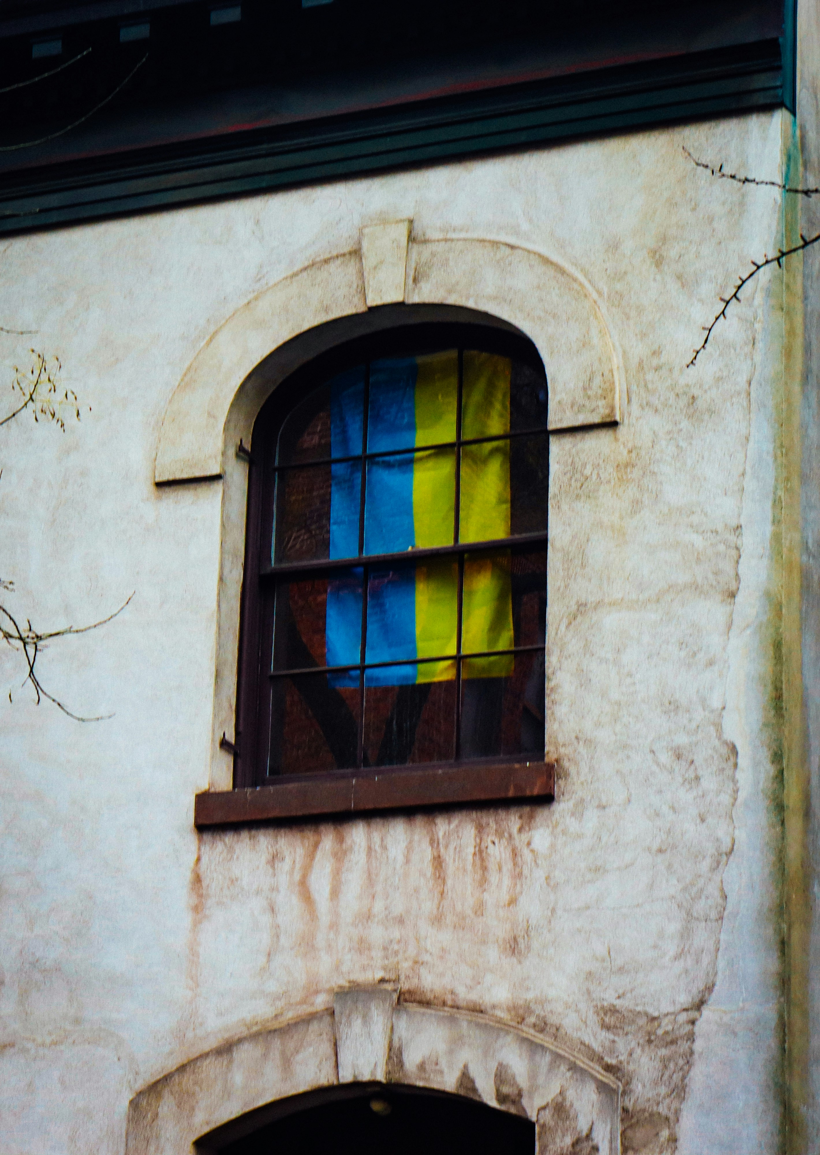 a window with a yellow and blue reflection in it