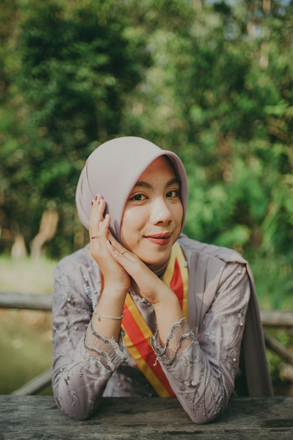 a woman wearing a hat and scarf posing for a picture