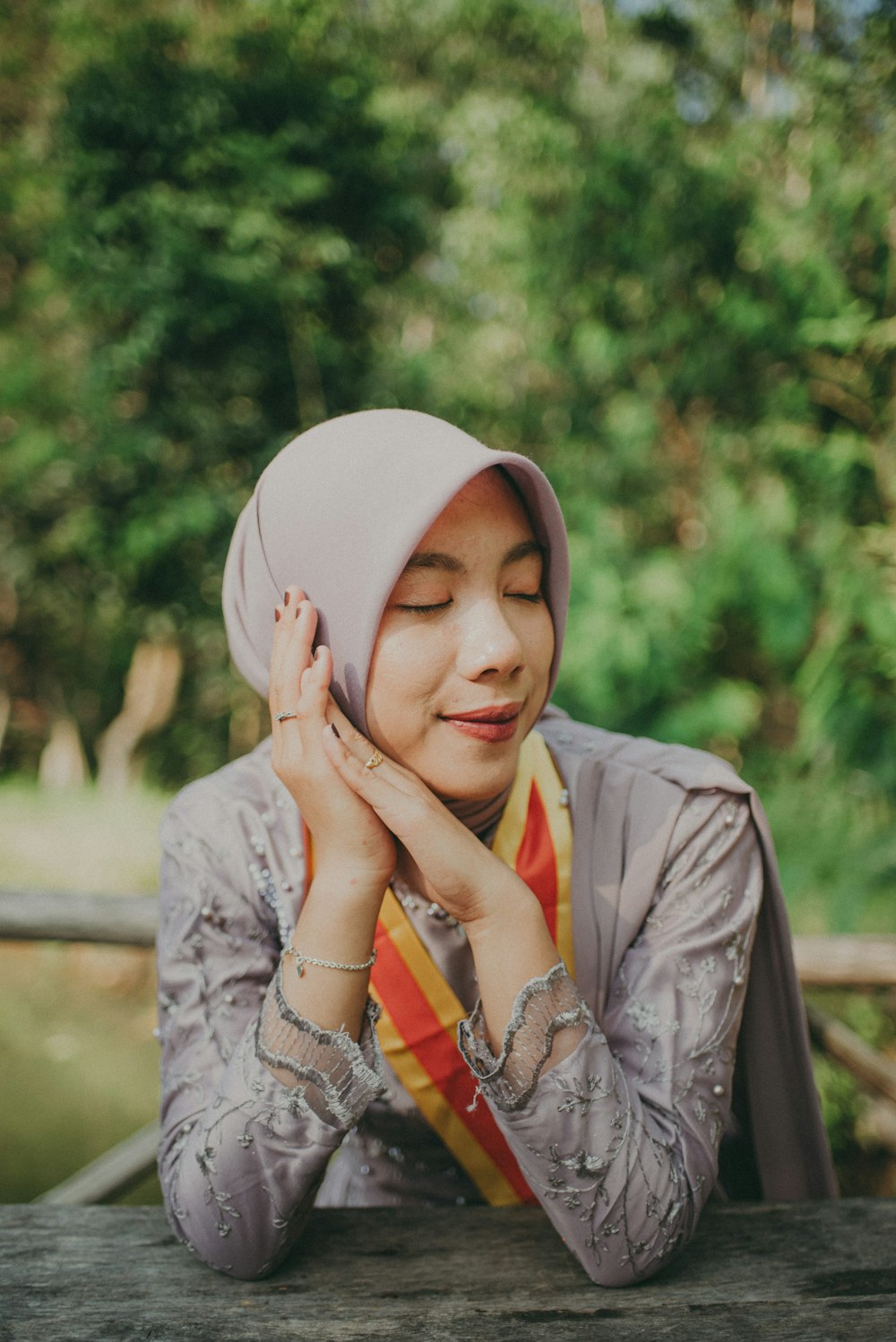 a woman wearing a hijab sitting at a table