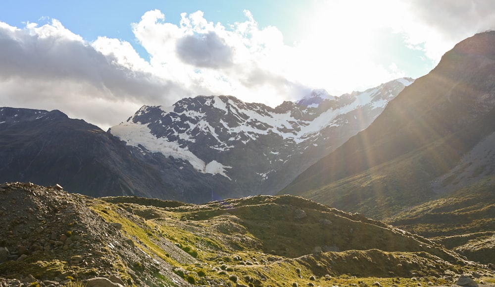 a view of a mountain range with snow capped mountains in the background