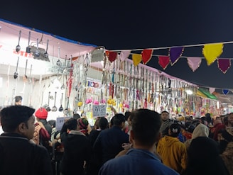 A lively market stall displaying Enchanted Chicken LLC’s handmade products with happy customers browsing.