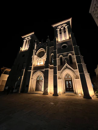 Evening shot of the parish hall glowing warmly with new lighting, ready for community events.