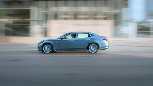 A sleek sedan driving through an urban landscape.