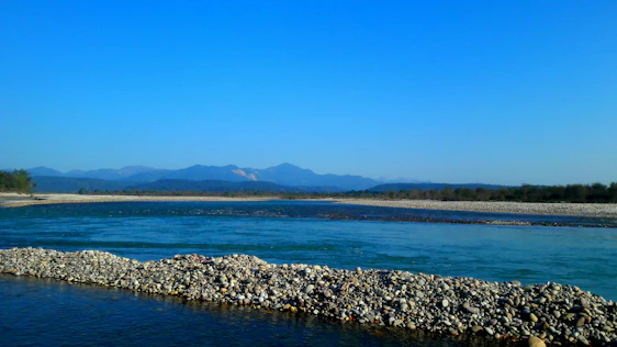 A serene blue glacier melting into a calm river, symbolizing clarity and flow in financial services.